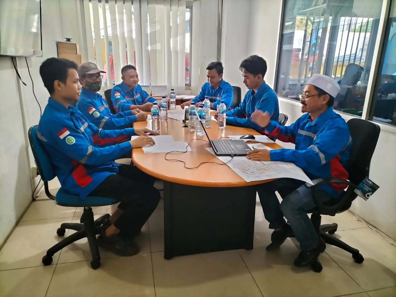 Frensiand team discussion with drawings and a laptop